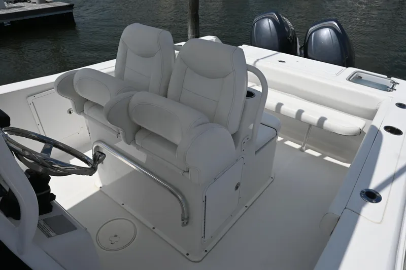 Slide: The Image of 2013 Sea Hunt Gamefish 27 boat interior with dual seats and steering wheel. - 27