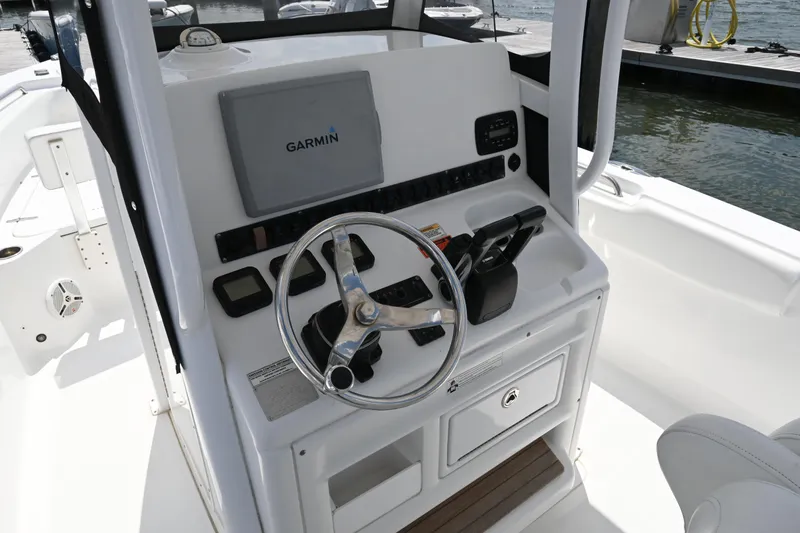 Slide: The Image of 2013 Sea Hunt Gamefish 27 helm with Garmin navigation system and steering wheel. - 28