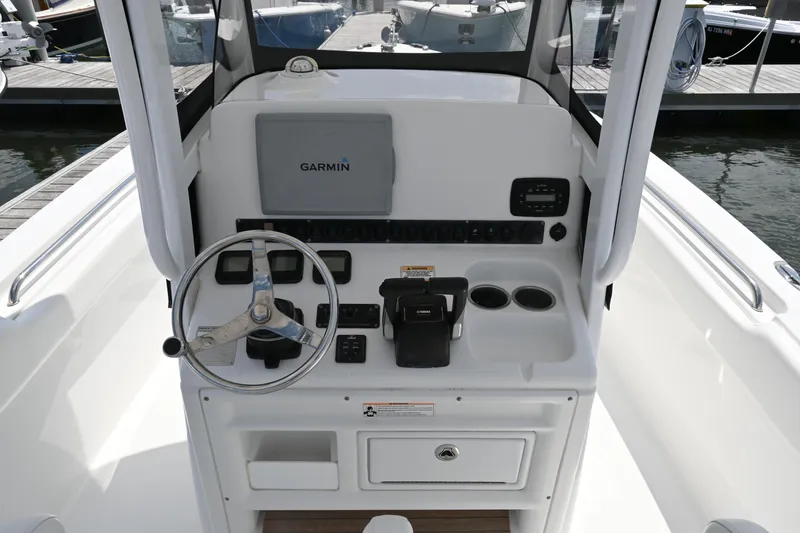 Slide: The Image of 2013 Sea Hunt Gamefish 27 helm with Garmin navigation system and steering wheel. - 29