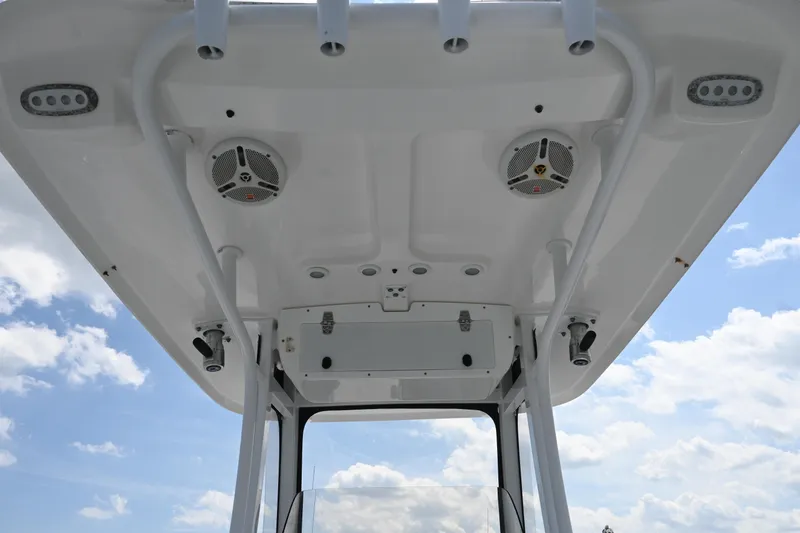 Slide: The Image of 2013 Sea Hunt Gamefish 27 boat roof with speakers and rod holders against blue sky. - 31