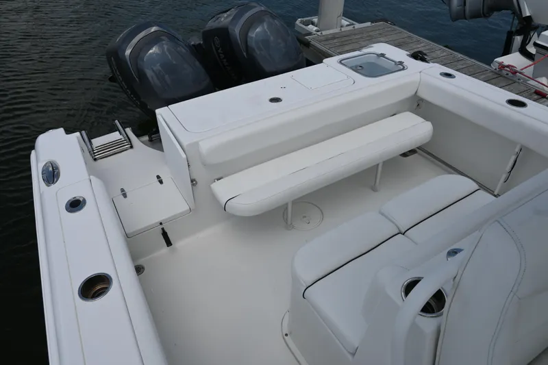 Slide: The Image of 2013 Sea Hunt Gamefish 27 boat interior with seating and dual outboard motors. - 33