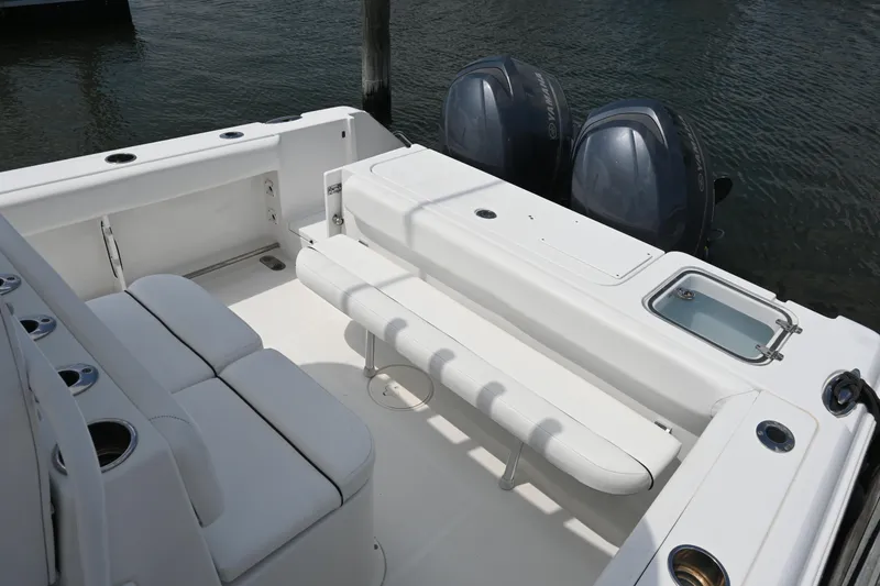 Slide: The Image of 2013 Sea Hunt Gamefish 27 boat interior with seating and dual outboard motors. - 34
