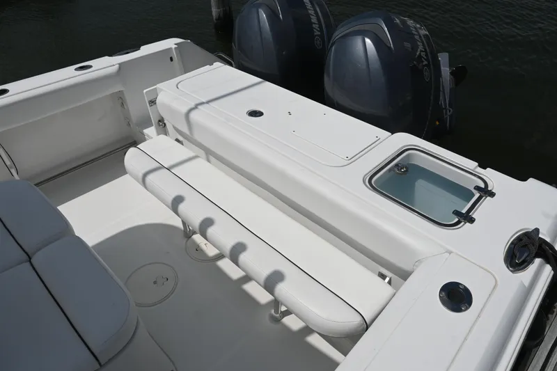 Slide: The Image of 2013 Sea Hunt Gamefish 27 boat interior with dual engines and seating area. - 36