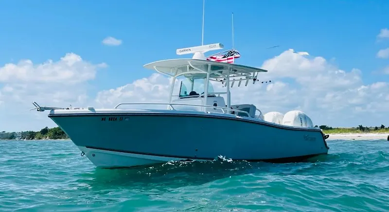 Slide: The Image of 2018 Mako 284 CC boat on clear blue water under a sunny sky. - 1