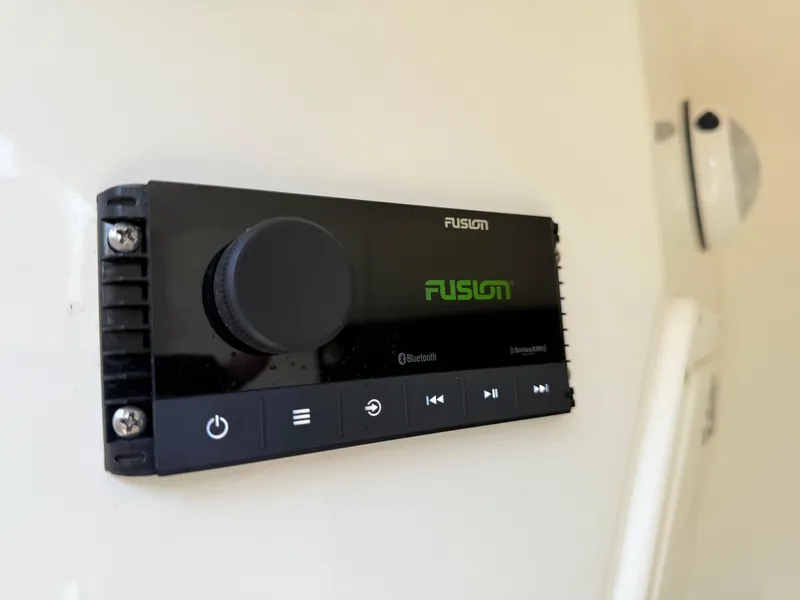 Slide: The Image of Fusion audio system on a 2018 Mako 284 CC boat, featuring Bluetooth connectivity. - 15