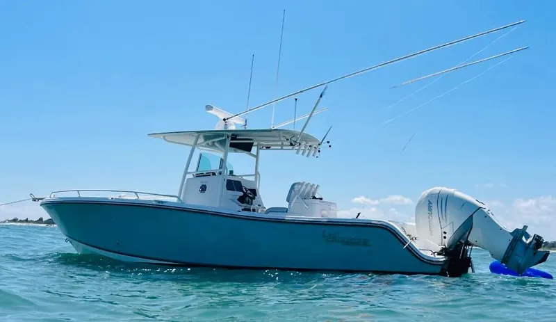 Slide: The Image of 2018 Mako 284 CC boat on water, clear sky background. - 2