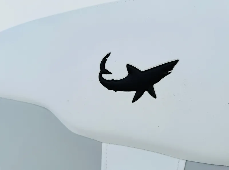 Slide: The Image of Black shark logo on white surface of 2018 Mako 284 CC boat. - 9