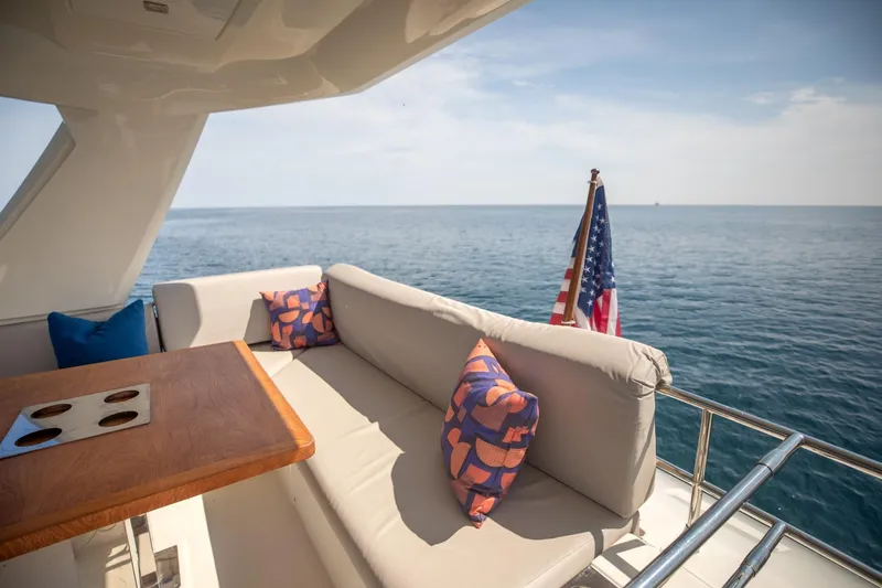 Slide: The Image of Luxurious 2020 Prestige 590 Flybridge Cruiser with elegant seating and ocean view. - 10