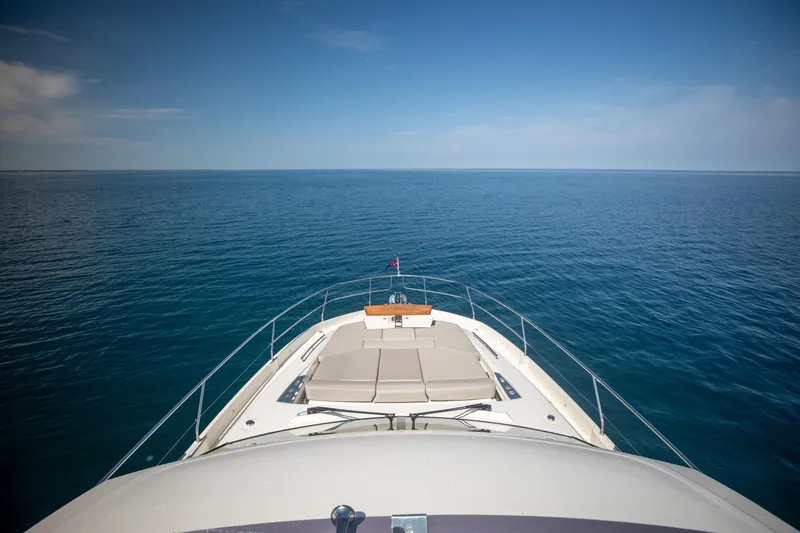 Slide: The Image of Prestige 590 Flybridge Cruiser 2020 on open sea, showcasing luxury and expansive ocean view. - 11