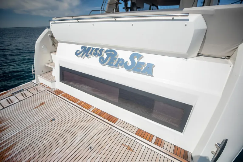 Slide: The Image of Prestige 590 Flybridge Cruiser 2020, rear deck view with "Miss Pep Sea" nameplate. - 14