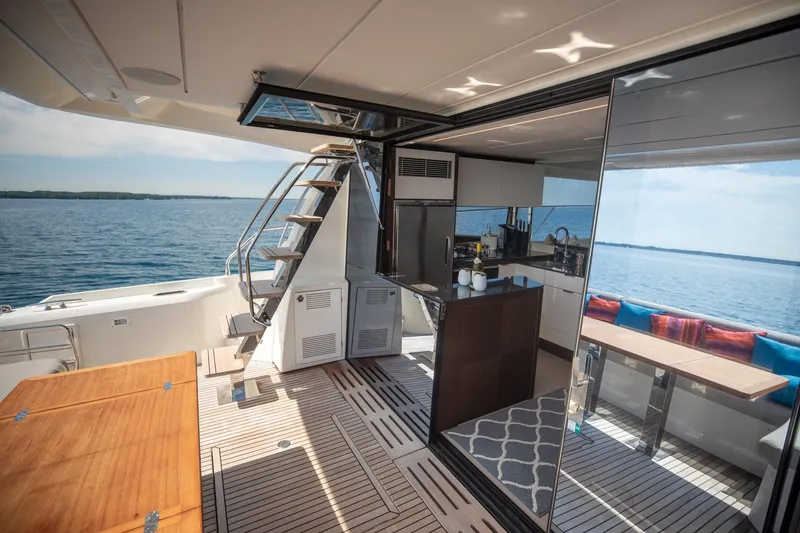 Slide: The Image of Luxurious 2020 Prestige 590 Flybridge Cruiser interior with modern kitchen and scenic ocean view. - 19