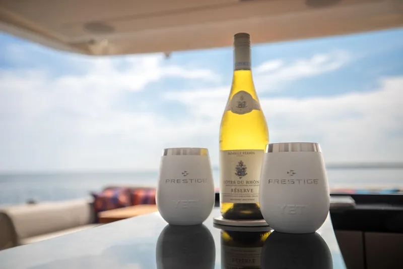 Slide: The Image of Wine and Prestige cups on 2020 Prestige 590 Flybridge Cruiser, ocean view. - 23