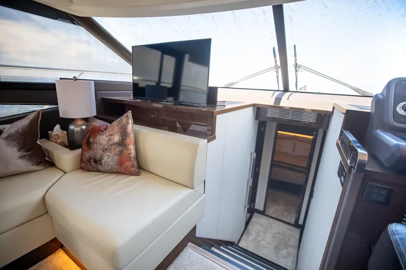 Slide: The Image of Luxurious interior of 2020 Prestige 590 Flybridge Cruiser with modern seating and TV. - 25