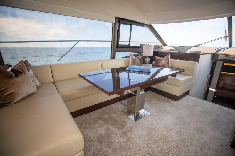 Slide: The Image of Luxurious interior of 2020 Prestige 590 Flybridge Cruiser with elegant seating and ocean view. - 30