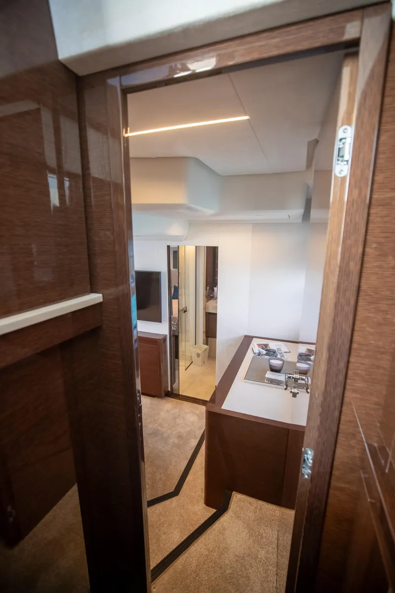 Slide: The Image of Interior view of 2020 Prestige 590 Flybridge Cruiser, showcasing elegant wood finishes and modern design. - 36