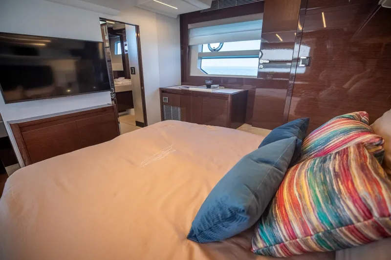 Slide: The Image of Luxurious bedroom interior of 2020 Prestige 590 Flybridge Cruiser with modern decor and vibrant pillows. - 44