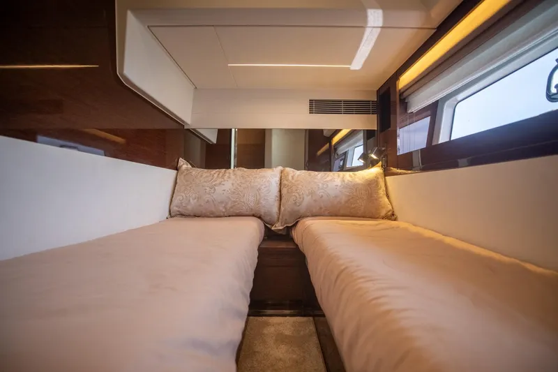 Slide: The Image of Luxurious interior of 2020 Prestige 590 Flybridge Cruiser with elegant twin beds. - 47