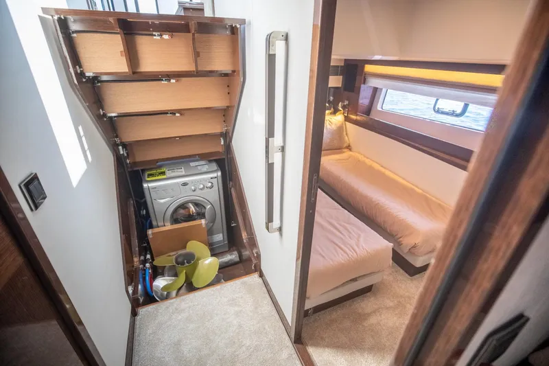 Slide: The Image of Laundry area and cozy cabin in 2020 Prestige 590 Flybridge Cruiser yacht. - 49