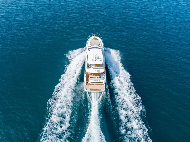 Slide: The Image of Aerial view of 2020 Prestige 590 Flybridge Cruiser navigating open blue waters. - 6