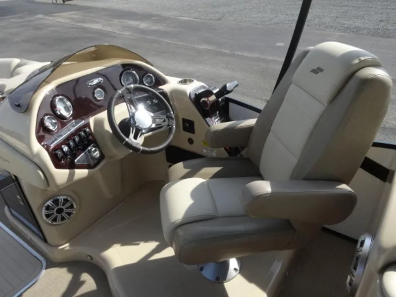 Slide: The Image of Captain's seat and dashboard of 2018 Starcraft MX23L boat, featuring modern controls and steering wheel. - 10