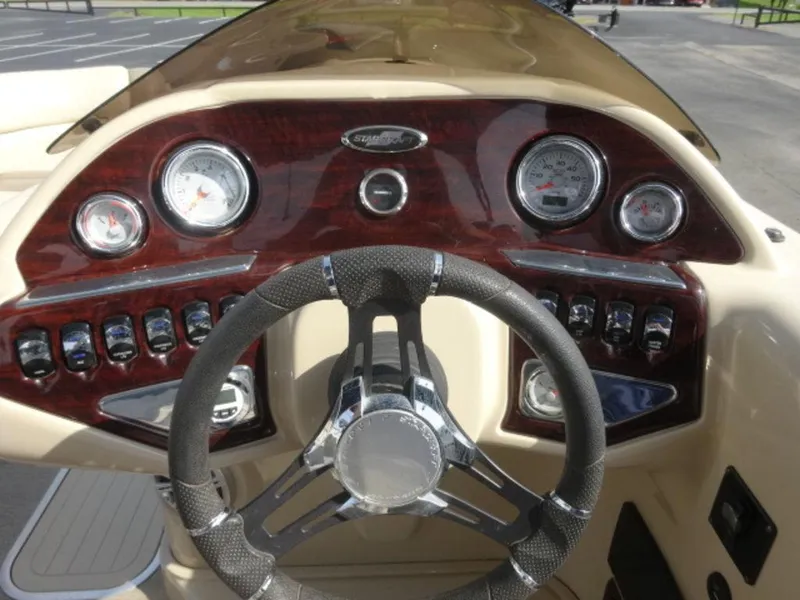 Slide: The Image of Dashboard of 2018 Starcraft MX23L boat with gauges and steering wheel. - 11