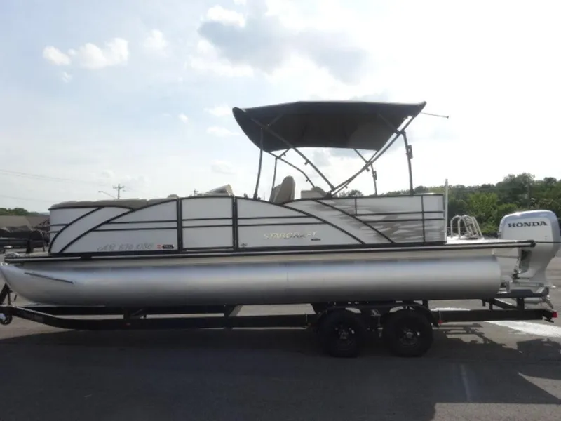 Slide: The Image of 2018 Starcraft MX23L pontoon boat with Honda outboard motor on trailer. - 5