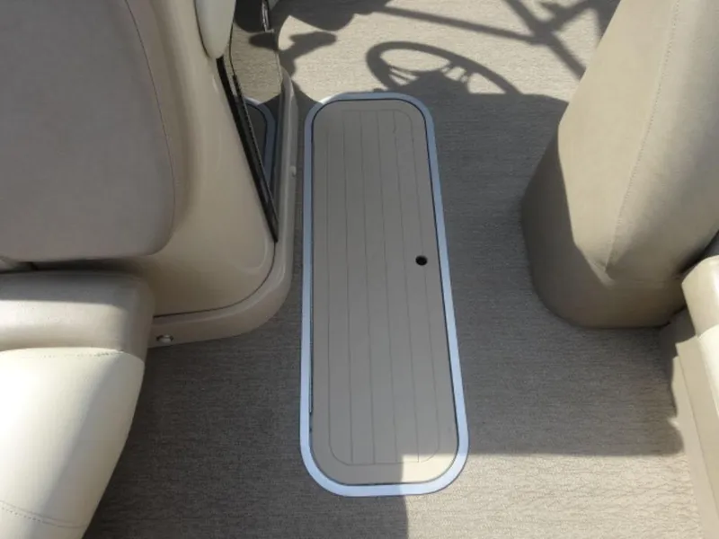 Slide: The Image of Interior view of a 2018 Starcraft MX23L boat, featuring beige seating and flooring. - 6