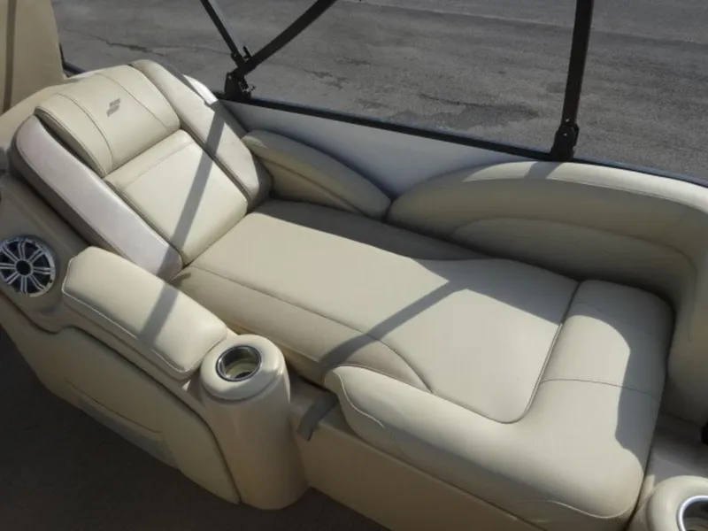 Slide: The Image of Luxurious beige seating on 2018 Starcraft MX23L boat, featuring cup holders and speaker. - 7