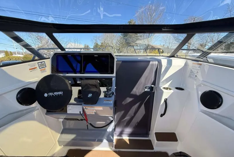 Slide: The Image of 2025 Navan S30 boat cockpit with modern controls, steering wheel, and navigation screens. - 16