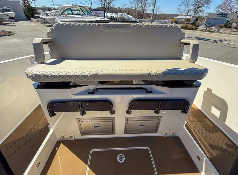 Slide: The Image of 2025 Navan S30 boat interior with cushioned seating and storage compartments. - 17