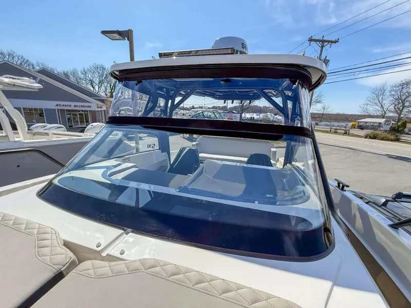 Slide: The Image of 2025 Navan S30 boat with sleek windshield and modern design, parked outdoors. - 2