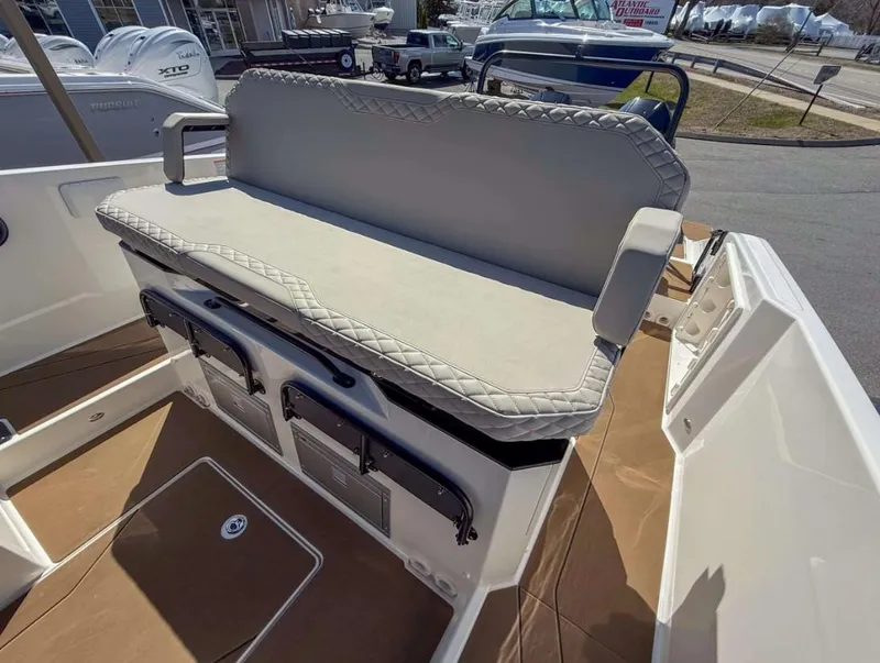 Slide: The Image of 2025 Navan S30 boat with cushioned seating and storage compartments. - 3