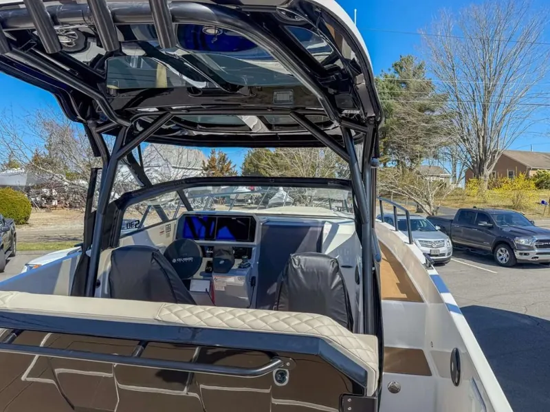 Slide: The Image of 2025 Navan S30 boat interior with modern dashboard and seating, parked outdoors. - 5