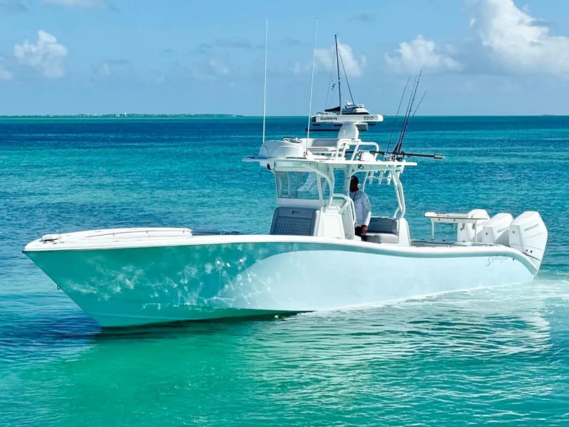 Slide: The Image of 2021 Yellowfin 36 Offshore boat cruising on clear turquoise waters. - 10