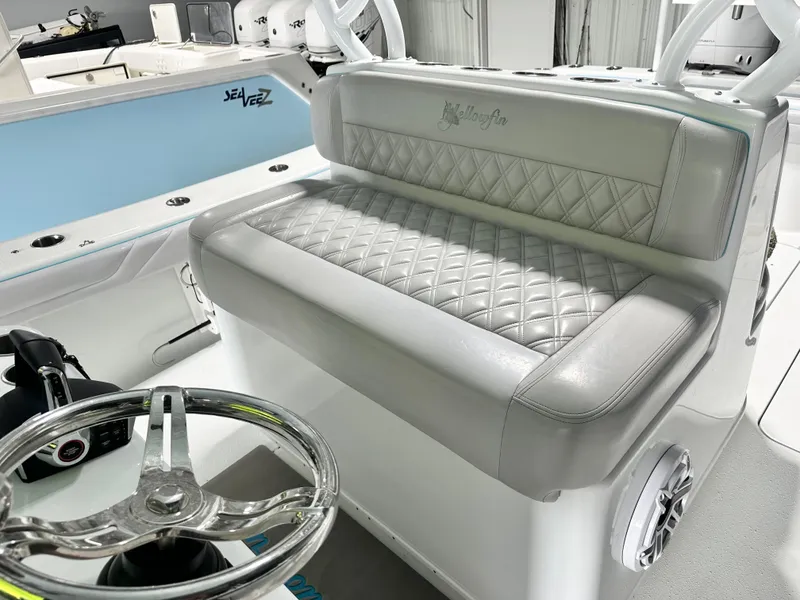 Slide: The Image of 2021 Yellowfin 36 Offshore boat interior with quilted seating and steering wheel. - 12