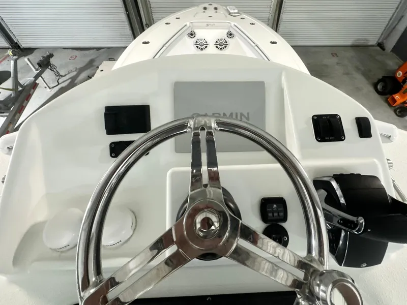 Slide: The Image of 2021 Yellowfin 36 Offshore boat helm with Garmin display and stainless steel steering wheel. - 16