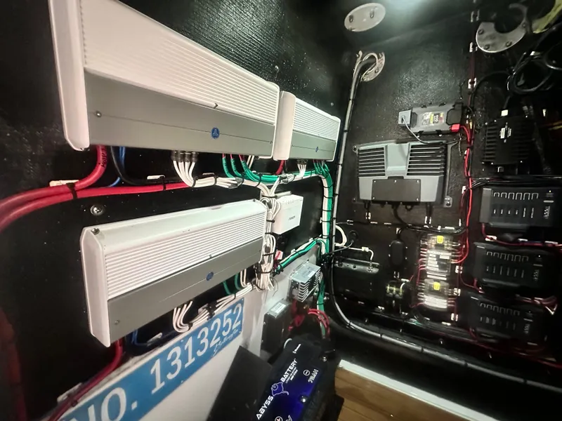 Slide: The Image of Electrical system inside a 2021 Yellowfin 36 Offshore boat, featuring wiring and components. - 18