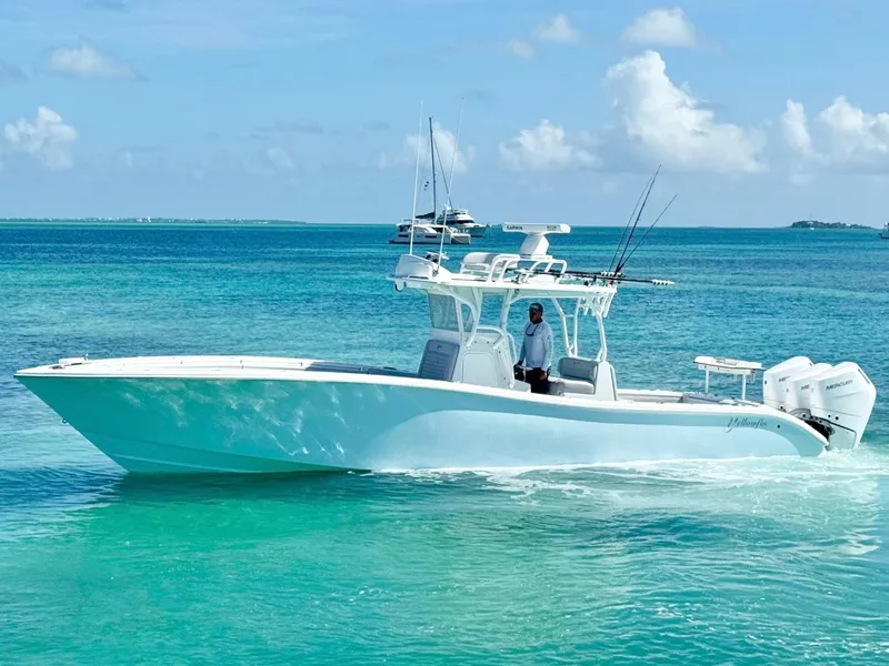 Slide: The Image of 2021 Yellowfin 36 Offshore boat cruising on clear turquoise waters. - 4