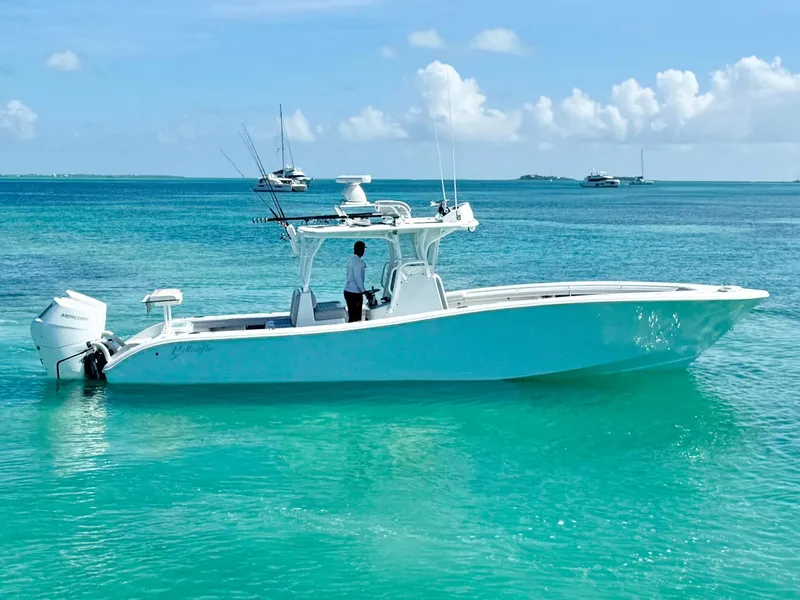 Slide: The Image of 2021 Yellowfin 36 Offshore boat on turquoise water, clear sky background. - 6