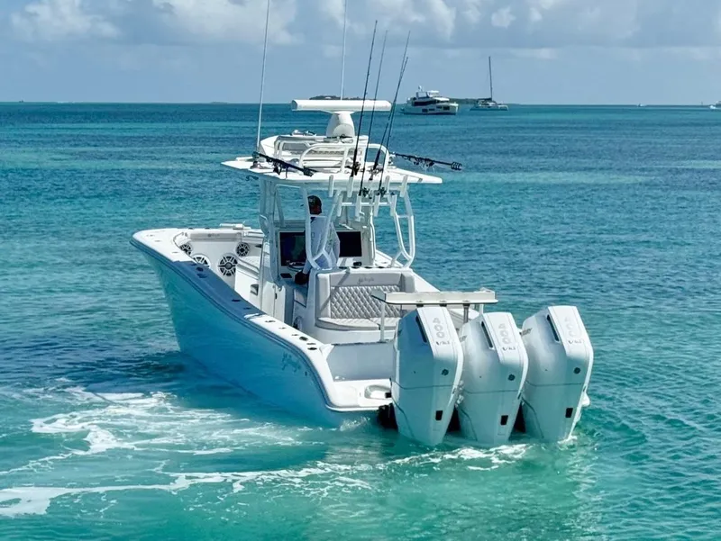 Slide: The Image of 2021 Yellowfin 36 Offshore boat with triple engines on clear blue water. - 7