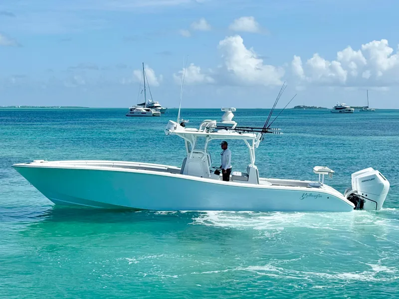 Slide: The Image of 2021 Yellowfin 36 Offshore boat cruising in clear turquoise waters. - 8