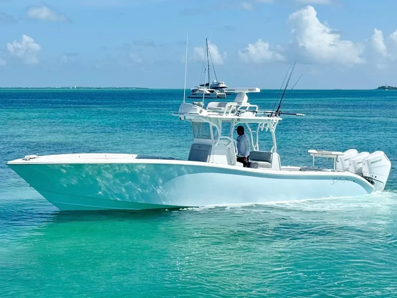 Slide: The Image of 2021 Yellowfin 36 Offshore boat cruising on clear turquoise water. - 9
