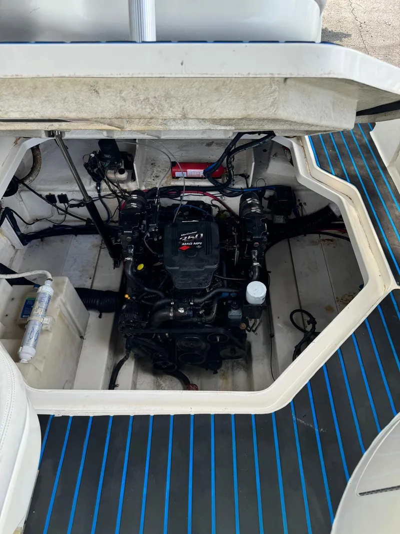 Slide: The Image of Engine compartment of a 2005 Sea Ray 260 Sundancer boat, showcasing the engine and interior layout. - 28