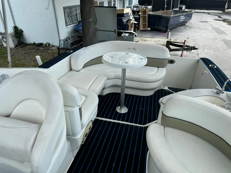 Slide: The Image of 2005 Sea Ray 260 Sundancer boat interior with white seating and table. - 8