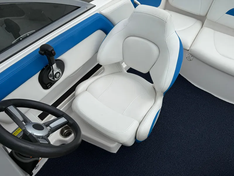 Slide: The Image of 2017 Chaparral 19 H2O Sport boat interior with white and blue seating and steering wheel. - 13