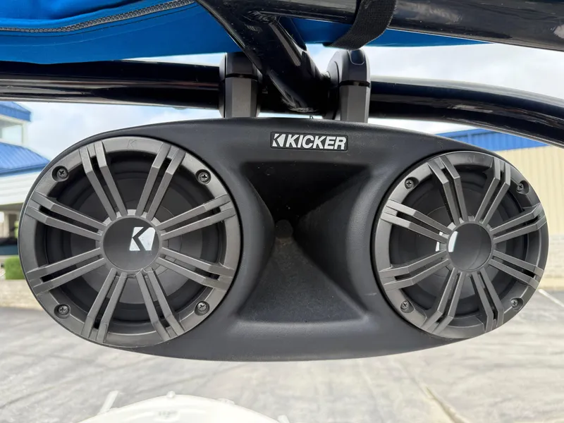 Slide: The Image of Kicker speakers on 2017 Chaparral 19 H2O Sport boat, mounted under blue canopy. - 16