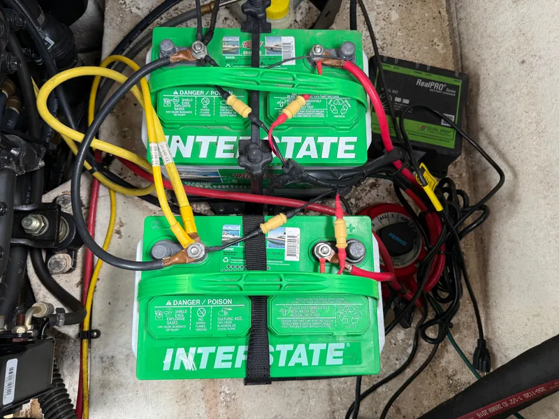 Slide: The Image of Two Interstate batteries connected with cables in a 2017 Chaparral 19 H2O Sport boat. - 18