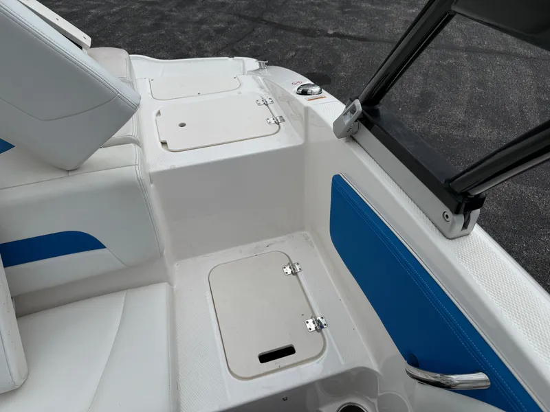 Slide: The Image of 2017 Chaparral 19 H2O Sport boat interior with white and blue seating. - 20