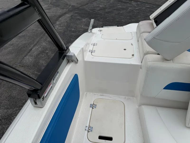 Slide: The Image of 2017 Chaparral 19 H2O Sport boat interior with white and blue seating. - 21