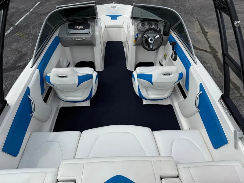 Slide: The Image of 2017 Chaparral 19 H2O Sport boat interior with blue and white seating. - 23